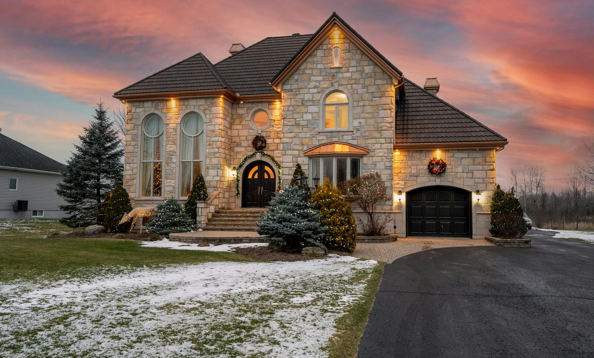 Stone house at sunset with early snow