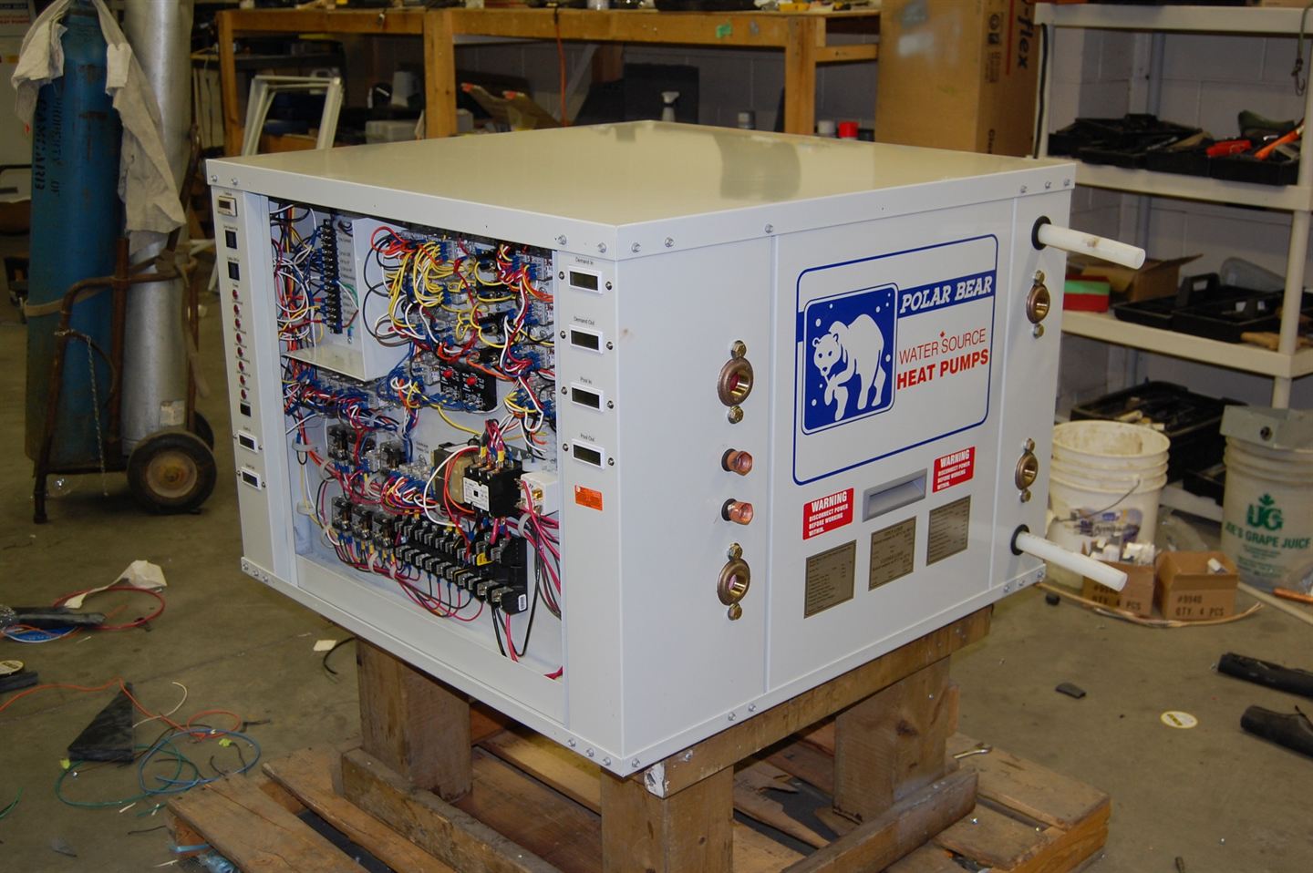 Heat pump cabinet with side panel removed showing wiring.